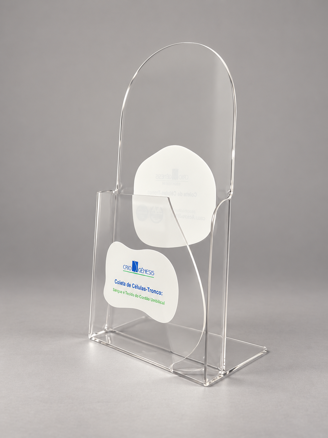 Display em PETG cristal com bolso frontal, recorte arredondado superior e berços internos para folders, em fundo neutro